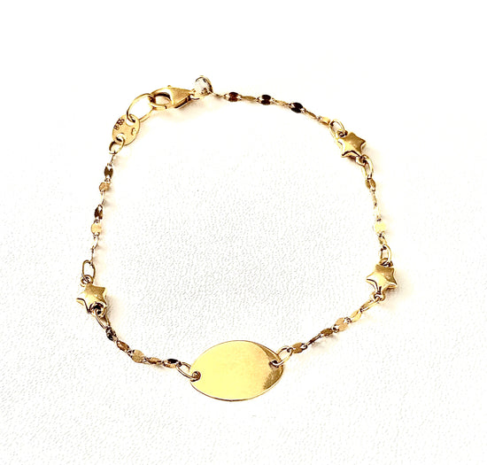 Pulsera de oro amarillo de chapita y estrellas