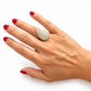 Anillo de plata dorada con forma de avellana cuajado de circonitas blancas